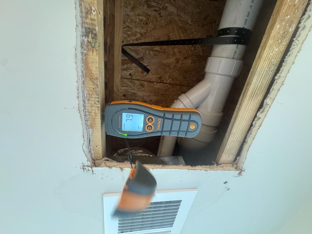 Technician checking moisture levels with a moisture meter in Longs, SC