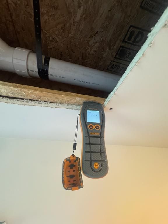 Technician checking moisture levels with a moisture meter in Longs, SC