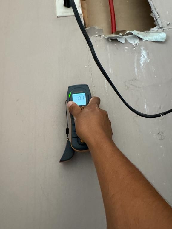 Technician checking moisture levels with a moisture meter in Myrtle Beach, SC