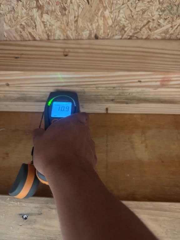 Technician checking moisture levels with a moisture meter in Sunset Beach, NC